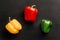 Flat lay composition with bright bell pepper on a black background