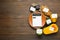 Flat lay composition of calculator and food products with calorific value tags on wooden table, space for text. Weight loss