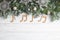 Flat lay composition with Christmas decor and music notes on white wooden table