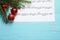 Flat lay composition with Christmas decorations and music sheet on blue wooden table