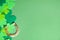 Flat lay composition with clover leaves and horseshoe on background, space for text. St. Patrick`s day