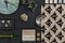 Flat lay composition of creative black architect mood board with samples of building, textile and natural materials and personal.