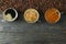 Flat lay composition with cups of coffee and coffee beans on wooden table, space for text