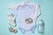 Flat lay composition with cute baby items on cyan background