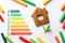 Flat lay composition with energy efficiency rating chart, colorful markers and house figure