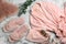 Flat lay composition with fluffy slippers and robe on white marble background. Comfortable home outfit