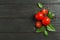 Flat lay composition with fresh tomatoes, salt, pepper and basil on wooden background, space for text