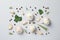 Flat lay of composition, garlic bulbs, slices, spice, parsley, rosemary on grey background, top view