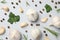 Flat lay of composition, garlic bulbs, spice, parsley, rosemary on grey background, top view. Closeup