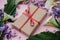 Flat lay composition with gift and wisteria, irises, white calla