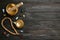 Flat lay composition with golden singing bowl on black wooden table, space for text. Sound healing