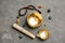 Flat lay composition with golden singing bowl on grey stone table. Sound healing