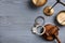 Flat lay composition with handcuffs, scales of justice and gavel on grey wooden table. Criminal law