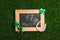 Flat lay composition with horseshoe and chalkboard on grass. St. Patrick`s Day celebration