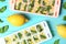 Flat lay composition with ice cube tray, mint and lemons