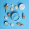 Flat lay composition with jars of body cream on blue background