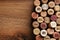 Flat lay composition with many wine corks with different dates on wooden table. Space for text