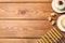 Flat lay composition of menorah, dreidels with He, Pe, Nun, Gimel letters and sufganiyot on wooden table, space for text. Hanukkah