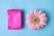 Flat lay composition with menstrual pads and gerbera flower. Gynecological care
