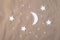 Flat lay composition of the moon and stars on the sheet. Dream creative concept
