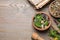 Flat lay composition with mortar and different healing  herbs on table, space for text