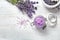 Flat lay composition with natural sugar scrub and lavender flowers on white wooden table. Cosmetic product