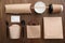 Flat lay composition with paper bags and different takeaway items on wooden background