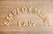 Flat lay composition with phrase EMPLOYMENT LAW on wooden background