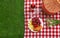 Flat lay composition with picnic basket and products on checkered blanket outdoor