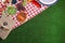 Flat lay composition with picnic basket and products on checkered blanket, space for