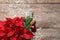 Flat lay composition with poinsettia and space for text on wooden background