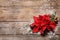 Flat lay composition with poinsettia and space for text on wooden background.