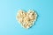 Flat lay composition with popcorn heart on blue background