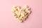 Flat lay composition with popcorn heart on pink background