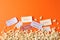 Flat lay composition with popcorn and tickets on orange background