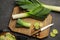 Flat lay composition with raw leek on dark grey table. Ripe onion