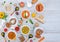 Flat lay composition of restaurant menu. top view of hot bowls with various soups with special wooden spoons on the side