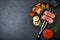 Flat lay composition with slices of grilled meat on black table