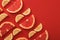 Flat lay composition with slices of  juicy exotic fruits on red background