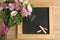 Flat lay composition with  and small blackboard for Teacher`s day on wooden background