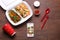 Flat lay composition with smartphone and takeout meal on wooden background. Food delivery