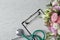 Flat lay composition with stethoscope and flowers on white wooden background. World health day
