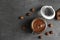 Flat lay composition with tasty chocolate cream in glass jar and hazelnuts on table.