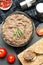 Flat lay composition with tasty liver pate on black table