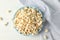 Flat lay composition. Towel and plate with popcorn on white wood