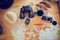 Flat lay composition with travel accessories on wooden table in motorhome. Summer trip