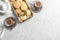 Flat lay composition with tray of cookies for Islamic holidays, cups and space for text on table.