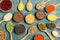 Flat lay composition with types of legumes and cereals on blue wooden table. Organic grains