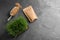 Flat lay composition with wheat grass, paper bag and grains on grey table