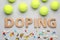 Flat lay composition with word Doping, tennis balls and drugs on light grey background